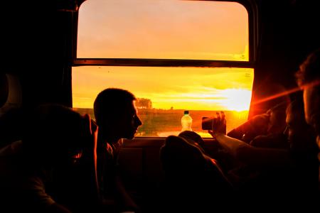 Silhouette of Man Sitting during Sunset