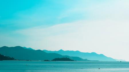 Silhouette of Mountain Near the Body of Water Photo in Daytime