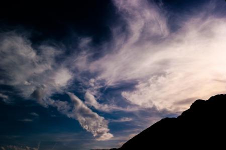 Silhouette of Mountain Under White Clouds