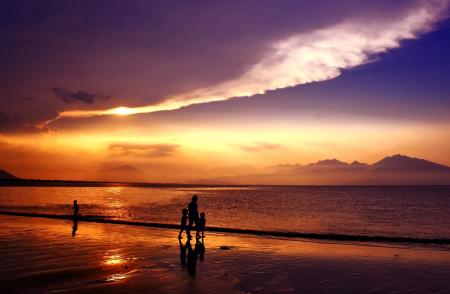 Silhouette of People Walking on Seashore Under Gray and White Clouds during Daytime