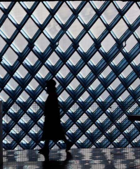 Silhouette of Person Walking Near Window