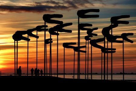 Silhouette Parasols Against Dramatic Sky during Sunset