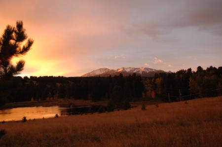Silhouette Photo of Grass Field With Body of Water and Mountains