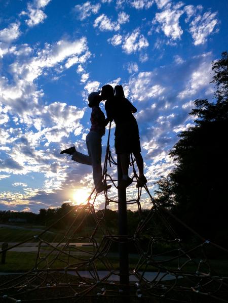 Silhouette Photo of Man and Woman Kissing Under White and Blue Sky during Sunset