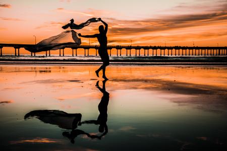 Silhouette Photo of Person Holding Scarf