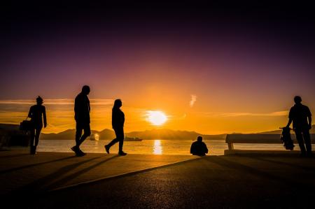 Silhouette Photography of People Near Body of Water