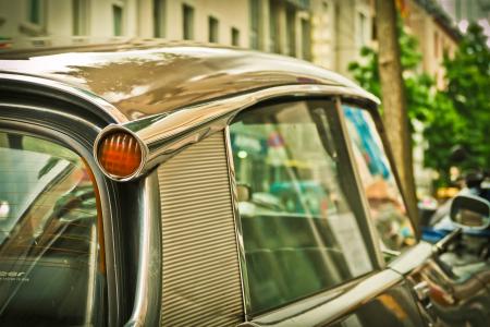 Silver Car Travelling Near White Concrete Building during Daytime Close Up Photo