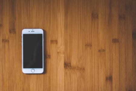 Silver Iphone 6 on Brown Wooden Surface