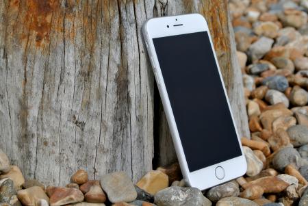 Silver Iphone 6 on Gray and Brown Stone