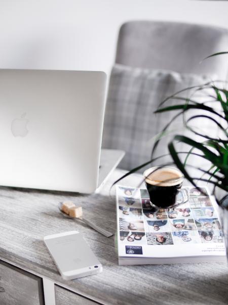 Silver Iphone Beside Book Under Cup Beside Silver Macbook