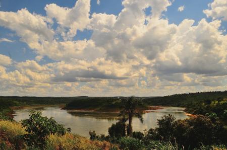 Small Body of Calm Water Under Cloudy Blue Sky at Daytime