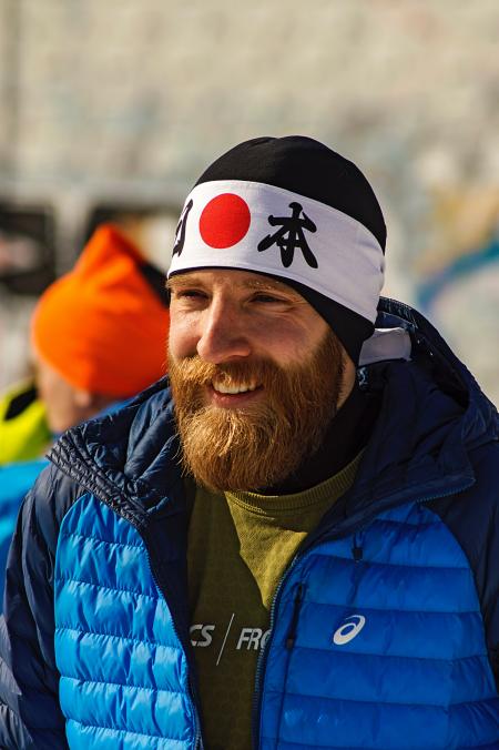 Smiling Man In Blue And Black Zip-up Bubble Jacket