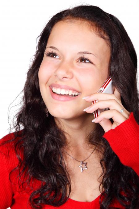 Smiling Woman Holding Smartphone