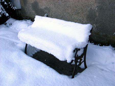 Snow-covered garden seat