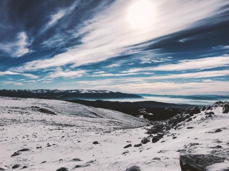 Snow Covered Hill Under Cloudy Blue Sky