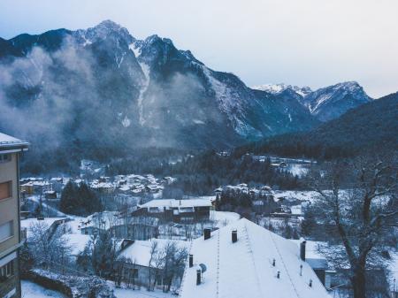 Snow Covered House Near Snow Covered Mountain Under Clear Sky