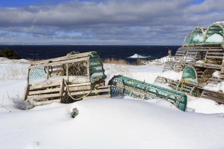 Snow covered lobster traps near ocean