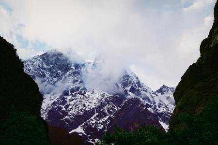 Snow Covered Mountain Under Cloudy Sky