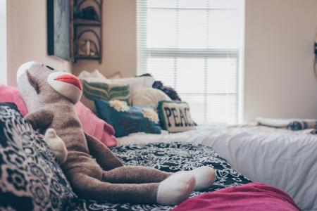 Sock Monkey Plush Toy On Bed