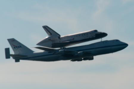 Space Shuttle Endeavour and carrier plane flying over San Francisco Bay - profile view