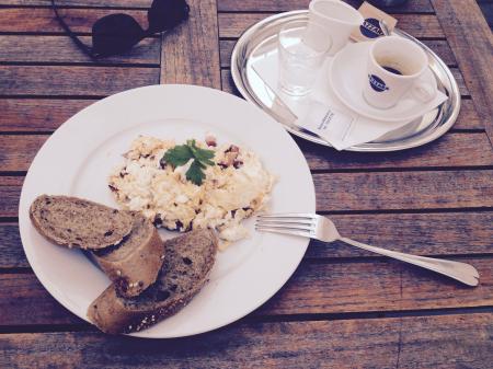 Stainless Steel Fork and White Ceramic Plate With Food on Top on Brown Wooden Table