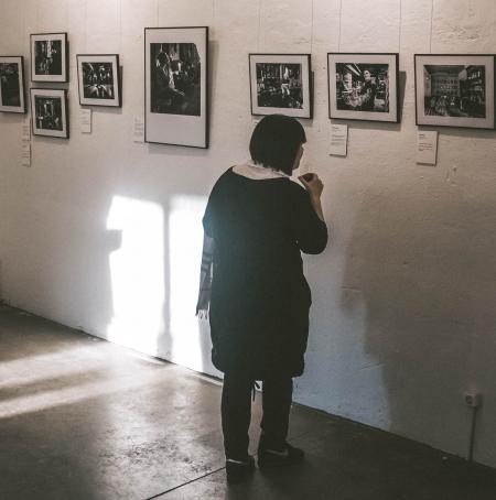 Standing Woman Looking at Photos