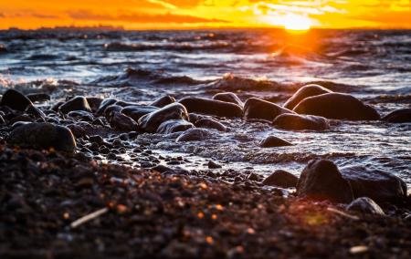 Stones Surrounded by Body of Water during Sunset