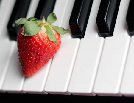 Strawberry on Top of Piano Keys