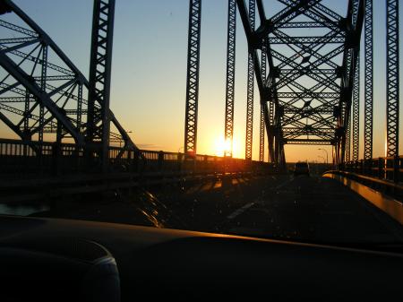 Sun set through a bridge