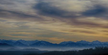 Tall Mountains Surrounded by Fogs Below the Clouds High-saturated Photography