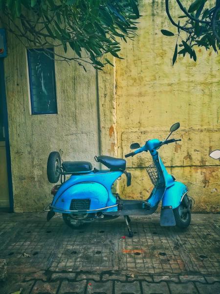 Teal Motor Scooter on Road