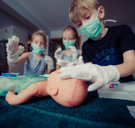 Three Children Playing Operation Toy