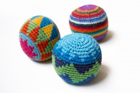 Three multi-colored juggling balls