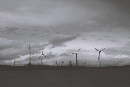 Three Wind Mills Under Cloudy Sky