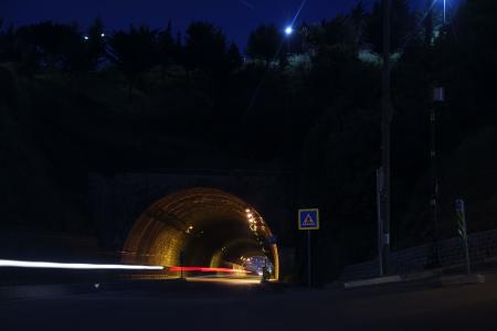 Time Laps Photography of Car Tunnel With Trees during Night Time