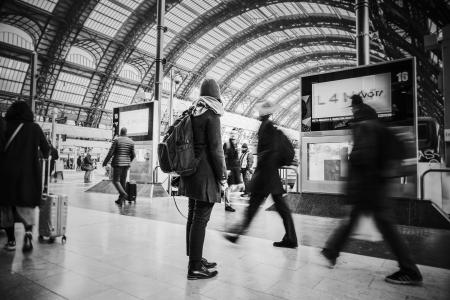 Time Lapse Grayscale Photograph of People Pass Through Inside Transportation Terminal