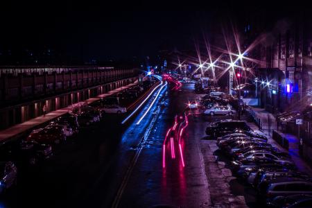 Time Lapse Photo of Cars Passing Near Parking Lot