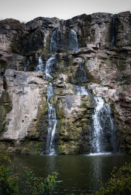 Timelaps Photo of White Green and Black Rock Falls during Daytime