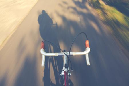 Timelapse Photography of a Person Riding a Road Bike