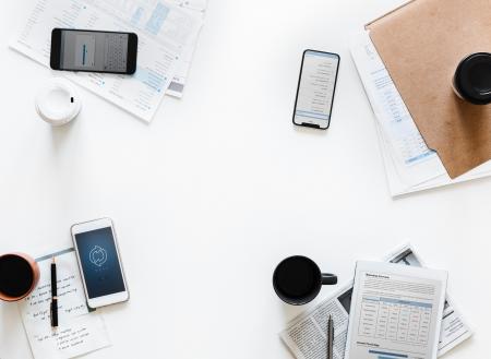 Top-view Photography of Smartphones and Papers on White Surface