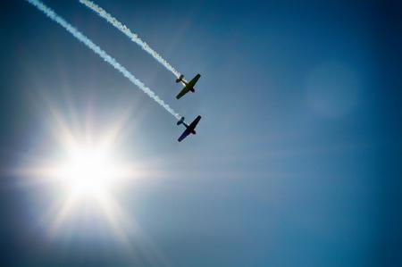 Two Airplane Flying Under Blue Sky Emitting White Smoke