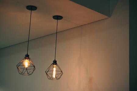 Two Black Pendant Lamp on White Concrete Ceiling