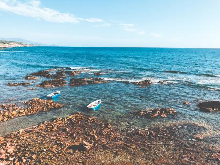 Two Blue Wooden Boats on Ocean Portrait