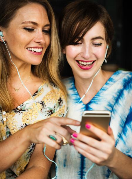 Two Girls Using Iphone