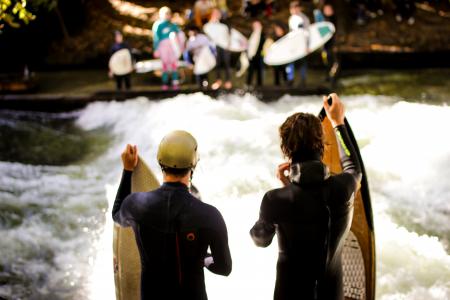 Two Men Wearing Black Wet Suits Holding Brown Wooden Surfboards