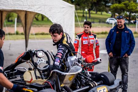 Two Motorcycle Racers Standing in Front of Motorcycles