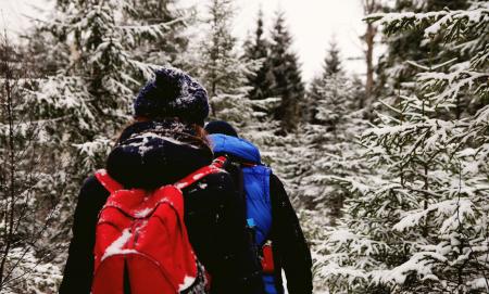 Two People Wearing Jacket And Red Backpack During Winter Season
