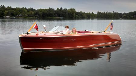 Two Person Riding Black Wooden Boats