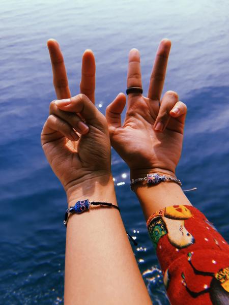 Two Person Wearing Owl Charm Bracelet