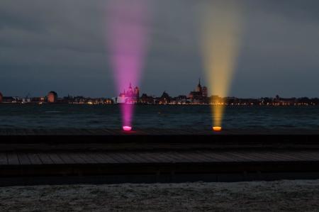 Two Purple and Orange Lights on Top of Brown Surface